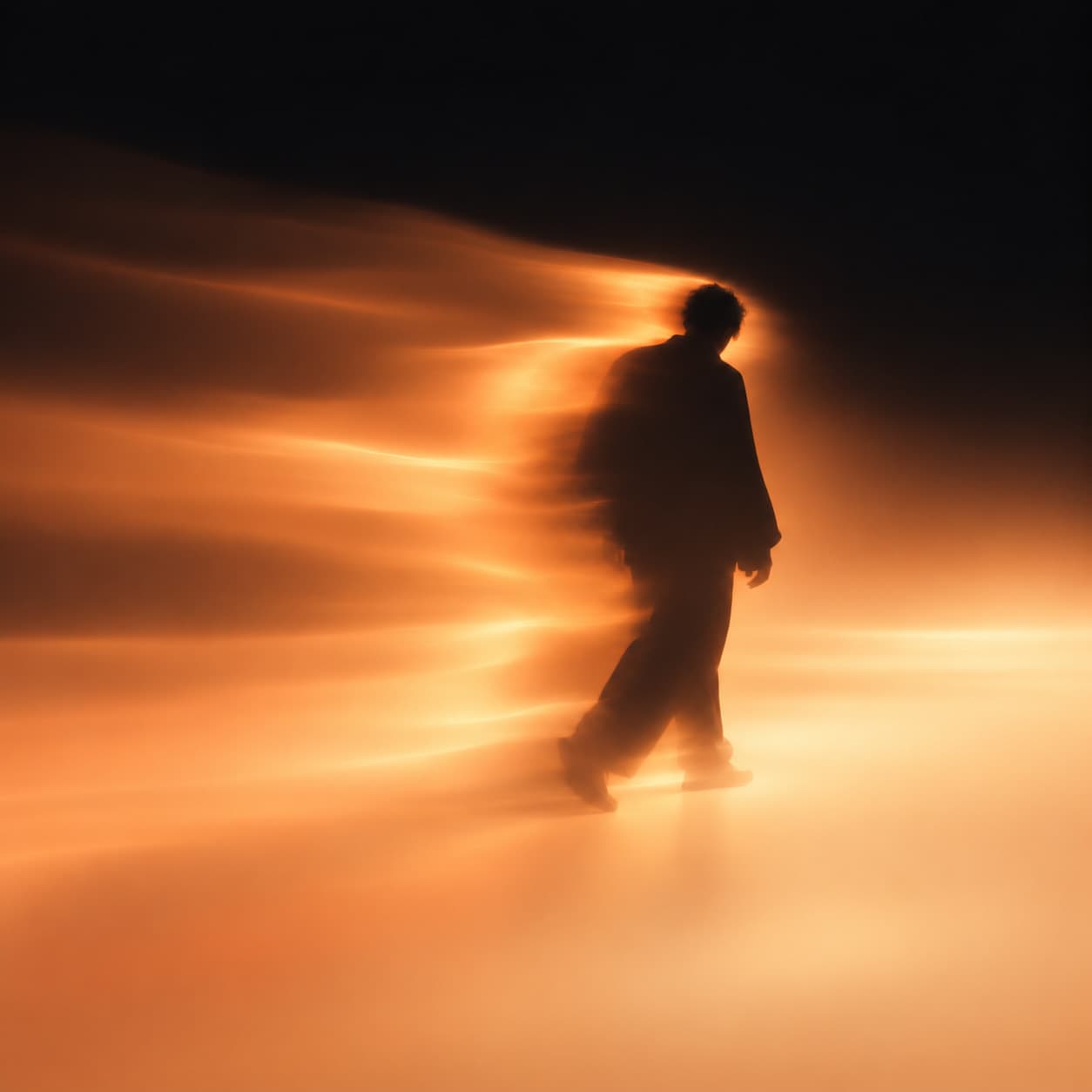A silhouette moving through warm light